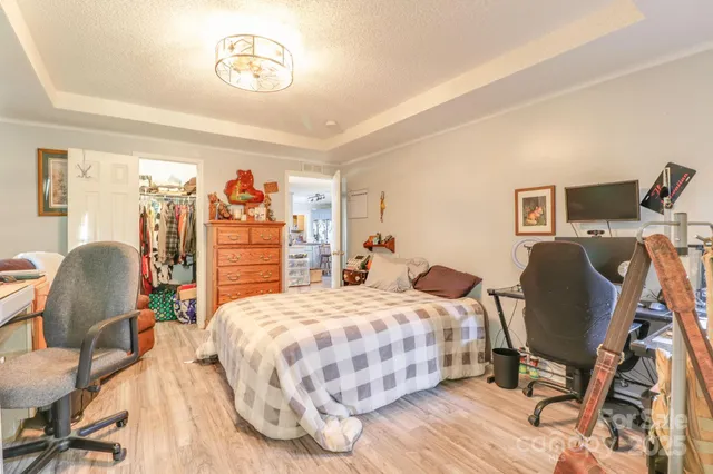 a bedroom with a bed chair and a desk