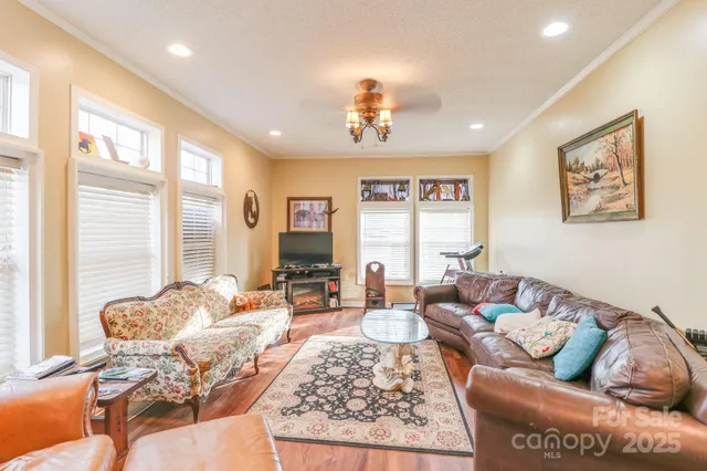 a living room with furniture two window and a table
