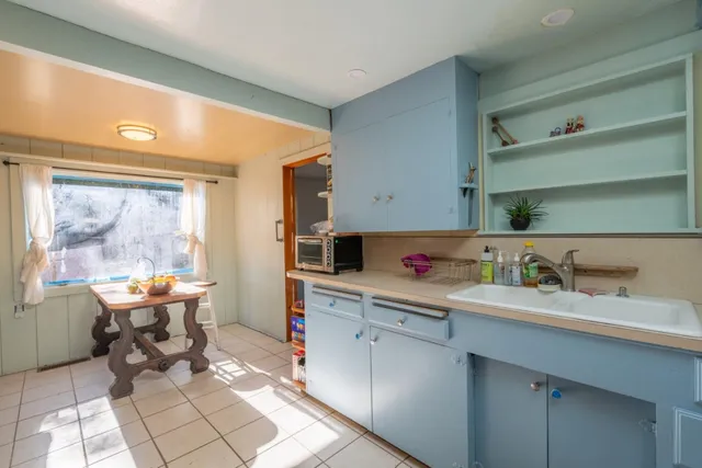 a kitchen with a sink cabinets and appliances