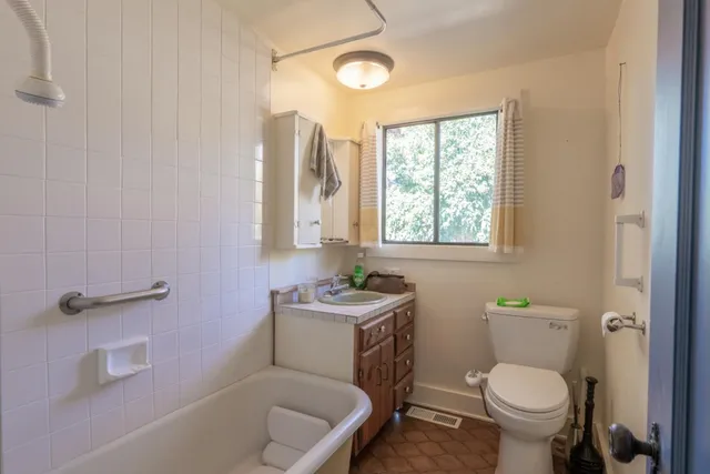 a bathroom with a toilet a sink and a bathtub