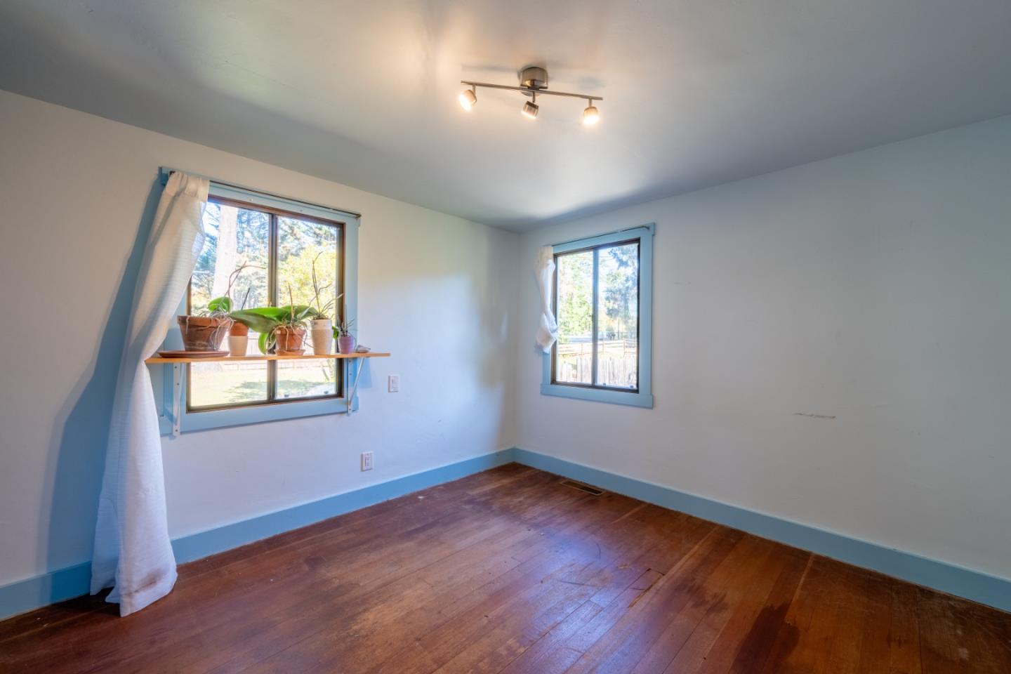 27415 Schulte Road Carmel, CA 93923 - Photo 8 of 30 a view of an empty room with wooden floor and a window