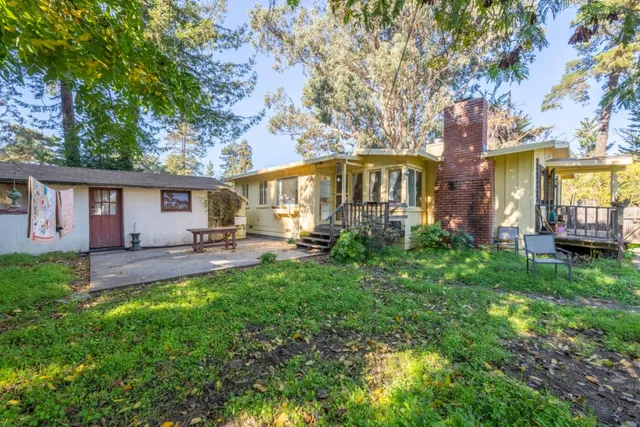 a front view of a house with patio and garden