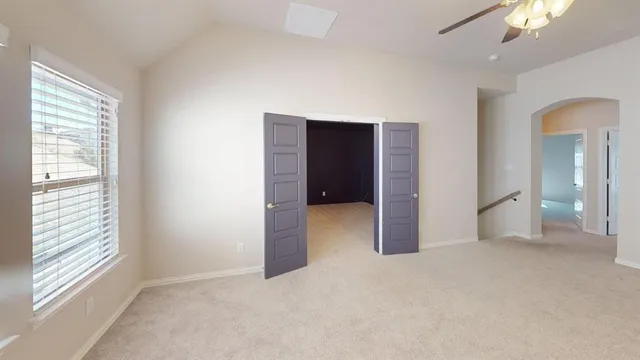 an empty room with windows and closet