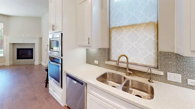 a kitchen with stainless steel appliances granite countertop a sink and a stove