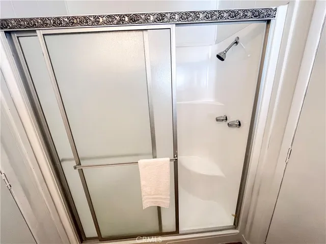 a bathroom with a glass shower door
