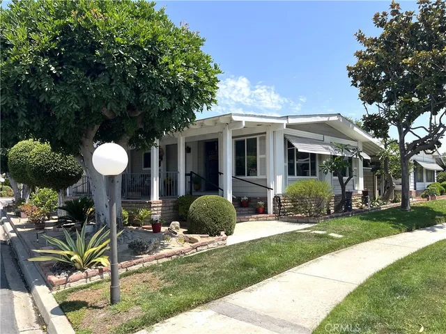 a view of a house with backyard porch and sitting area