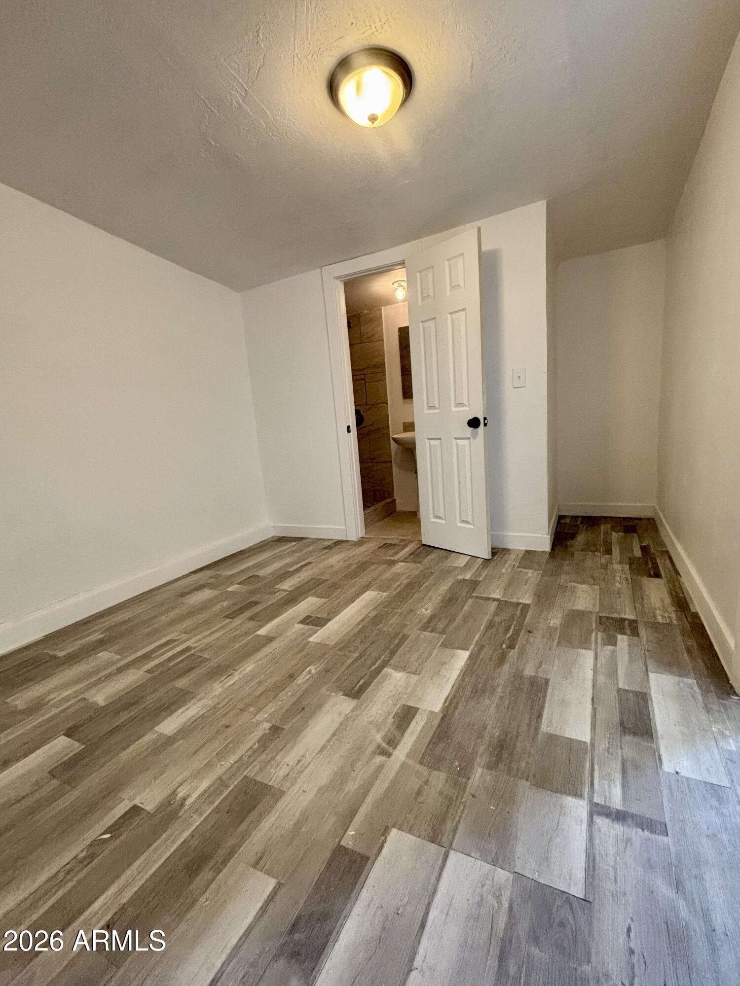 3036 West Almeria Road Phoenix, AZ 85009 - Photo 13 of 20 a view of a livingroom with wooden floor and closet