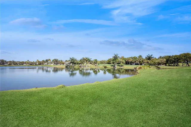 a view of a lake with houses in the back
