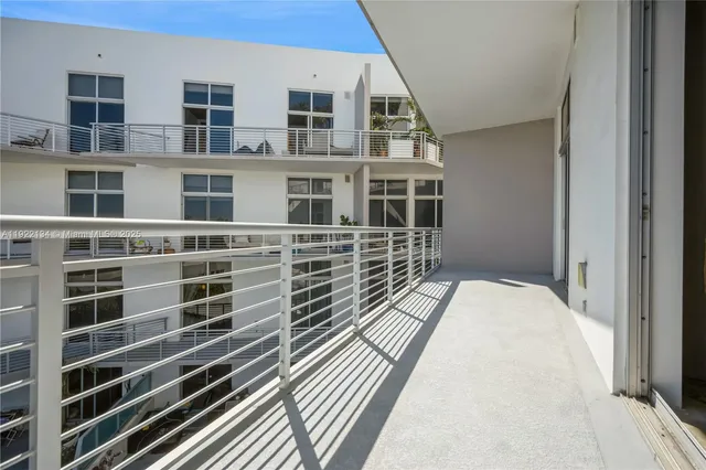 a view of balcony with wooden floor and fence