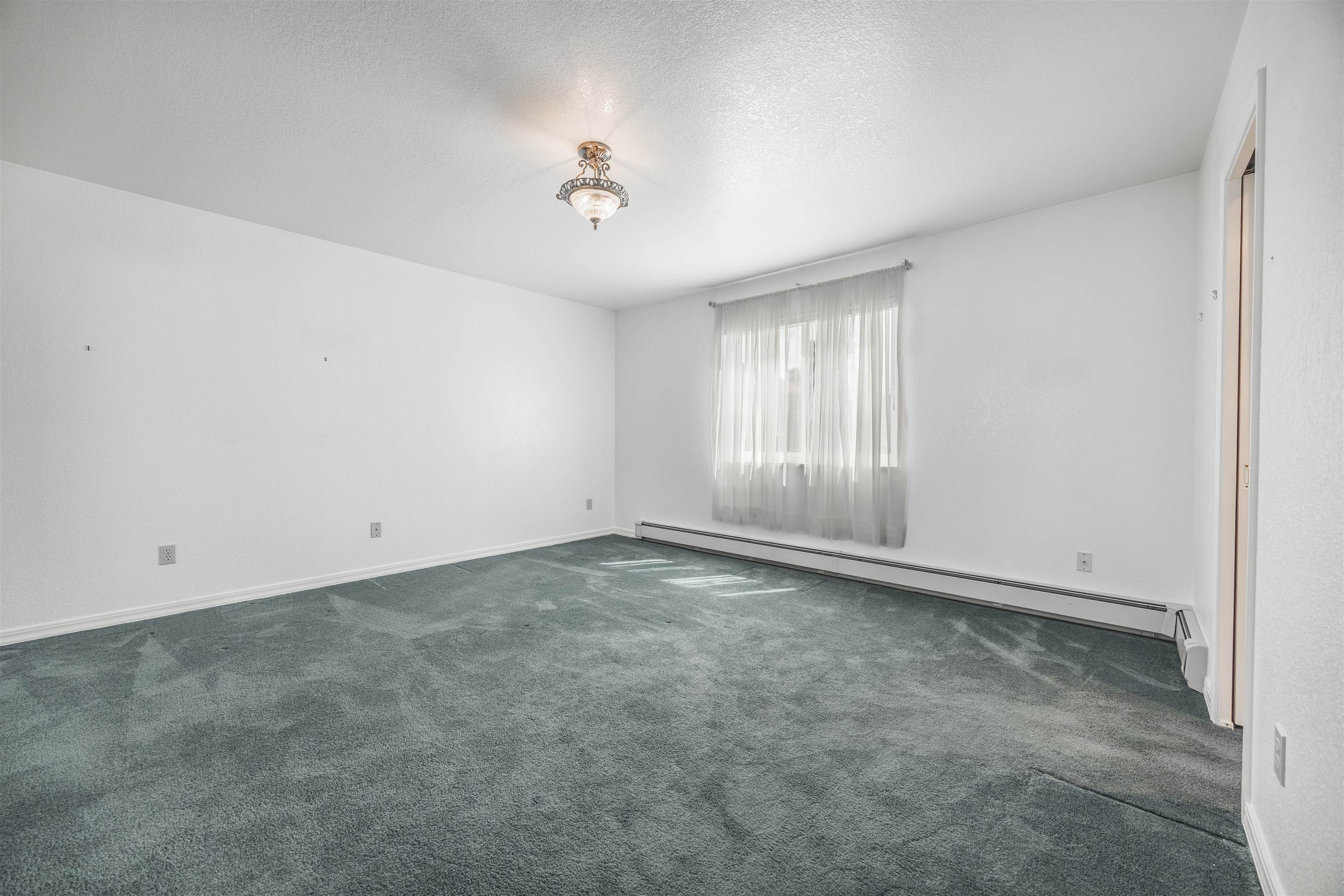 2135 Winston Way, Unit B Montrose, CO 81401 - Photo 15 of 23 an empty room with a empty space and windows