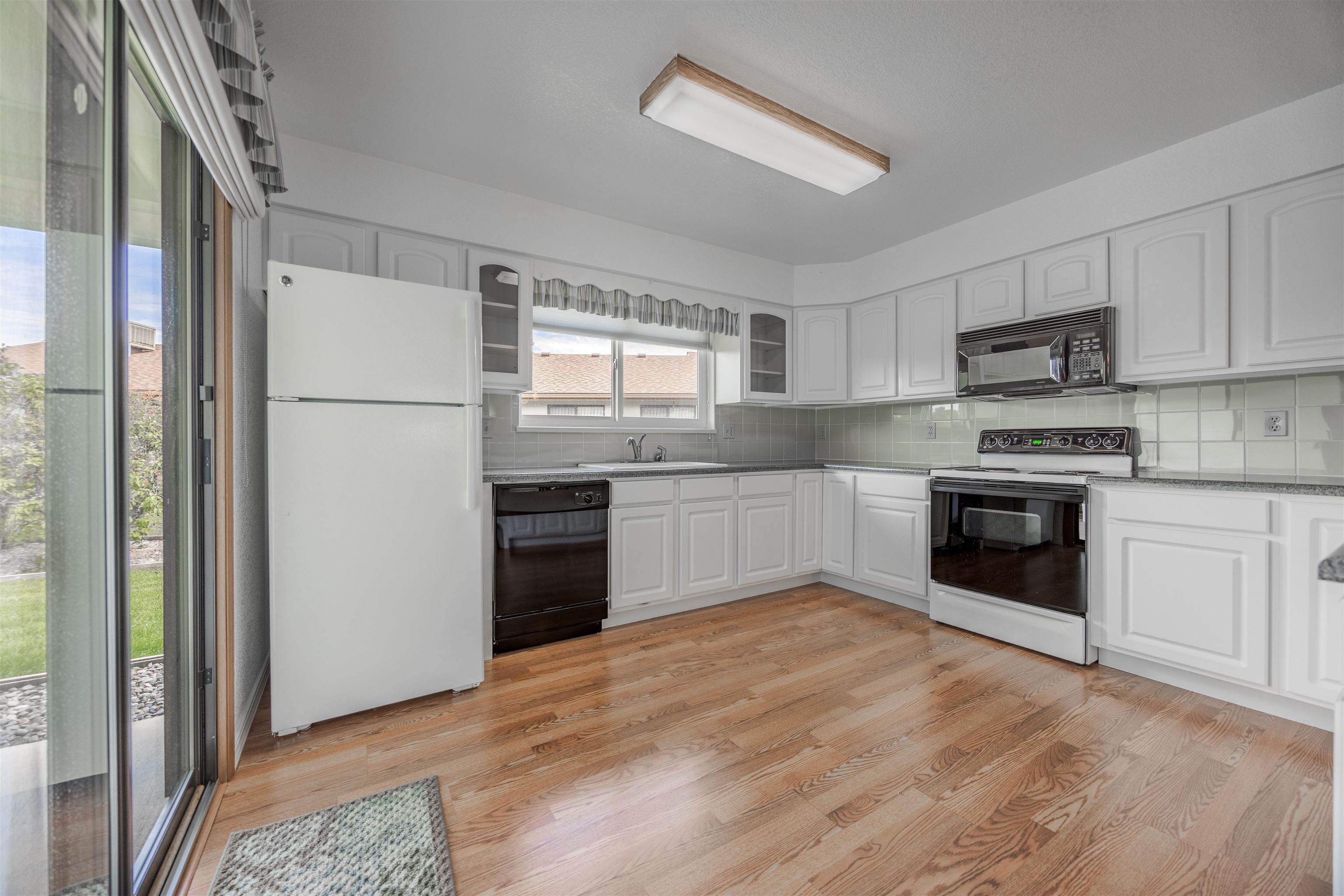 2135 Winston Way, Unit B Montrose, CO 81401 - Photo 7 of 23 a kitchen with a white cabinets and white appliances