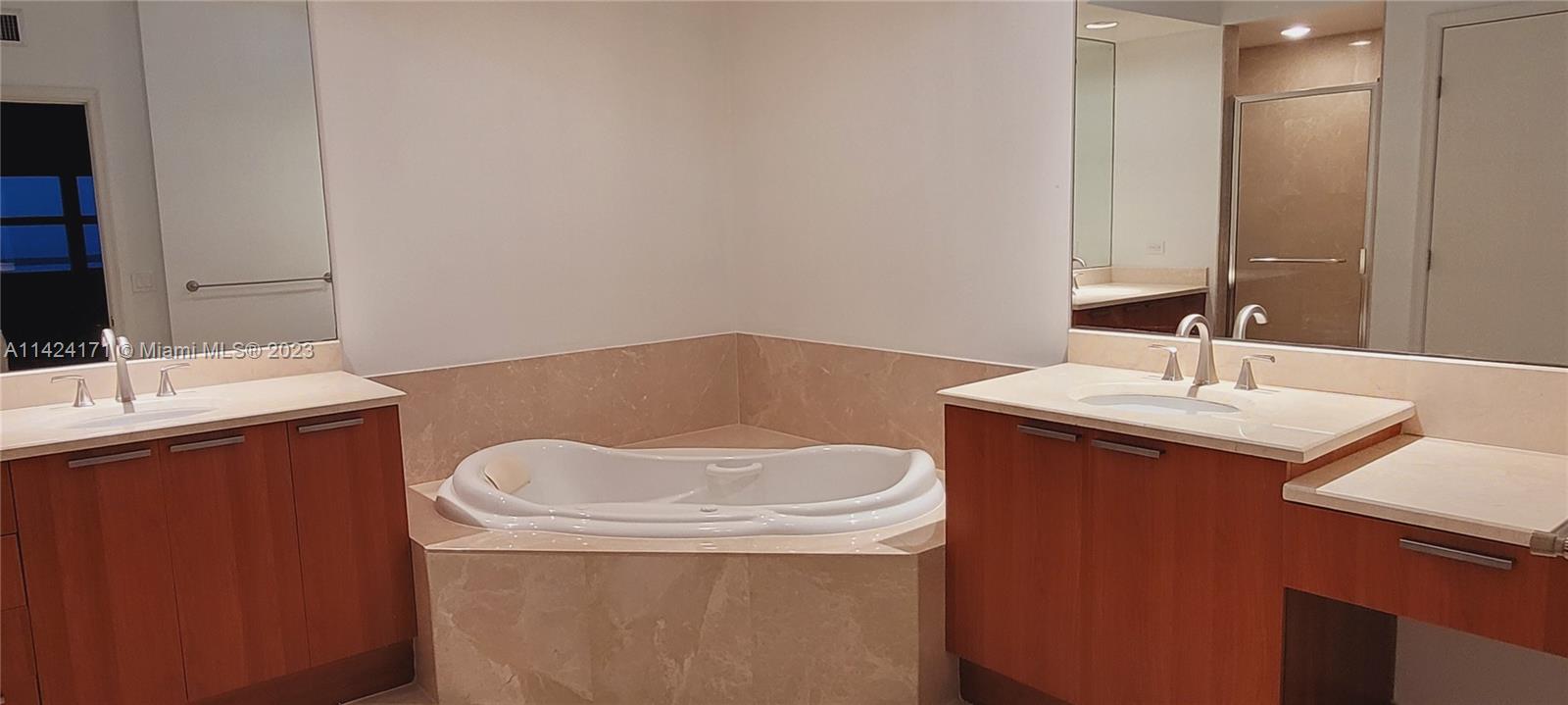 2650 Lake Shore Drive, Unit 2202 Riviera Beach, FL 33404 - Photo 14 of 29 a bathroom with a sink toilet and mirror