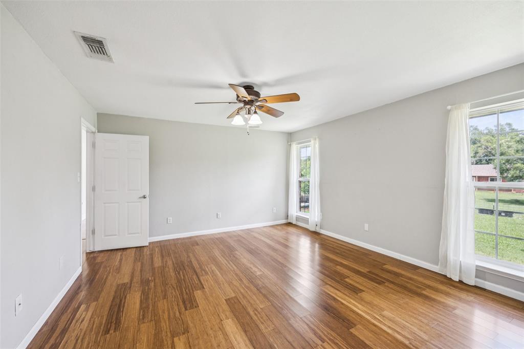 1 Glen Cove Circle Lucas, TX 75002 - Photo 15 of 37 a view of a room with wooden floor and a ceiling fan