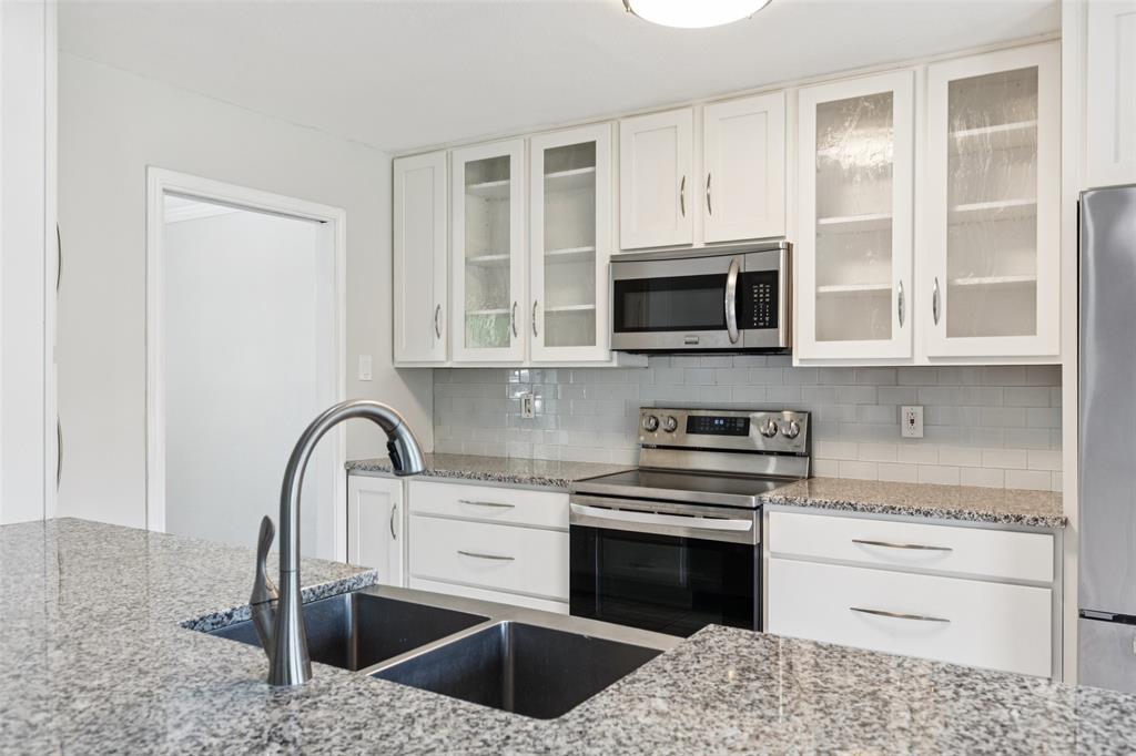1 Glen Cove Circle Lucas, TX 75002 - Photo 5 of 37 a kitchen with granite countertop a stove and a microwave