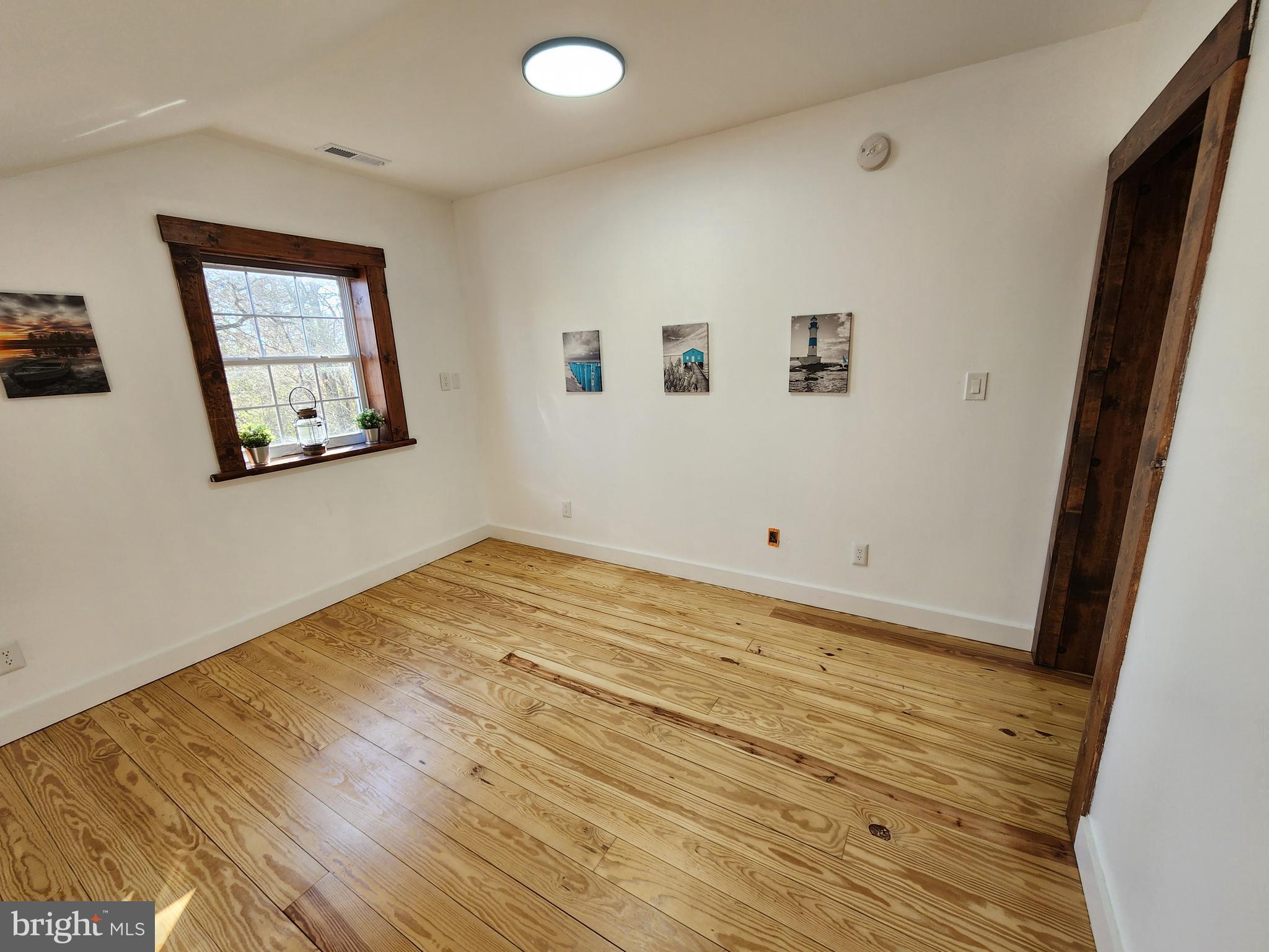 6366 Galestown-Reliance Road Federalsburg, MD 21632 - Photo 17 of 55 a view of a room with wooden floor and white walls