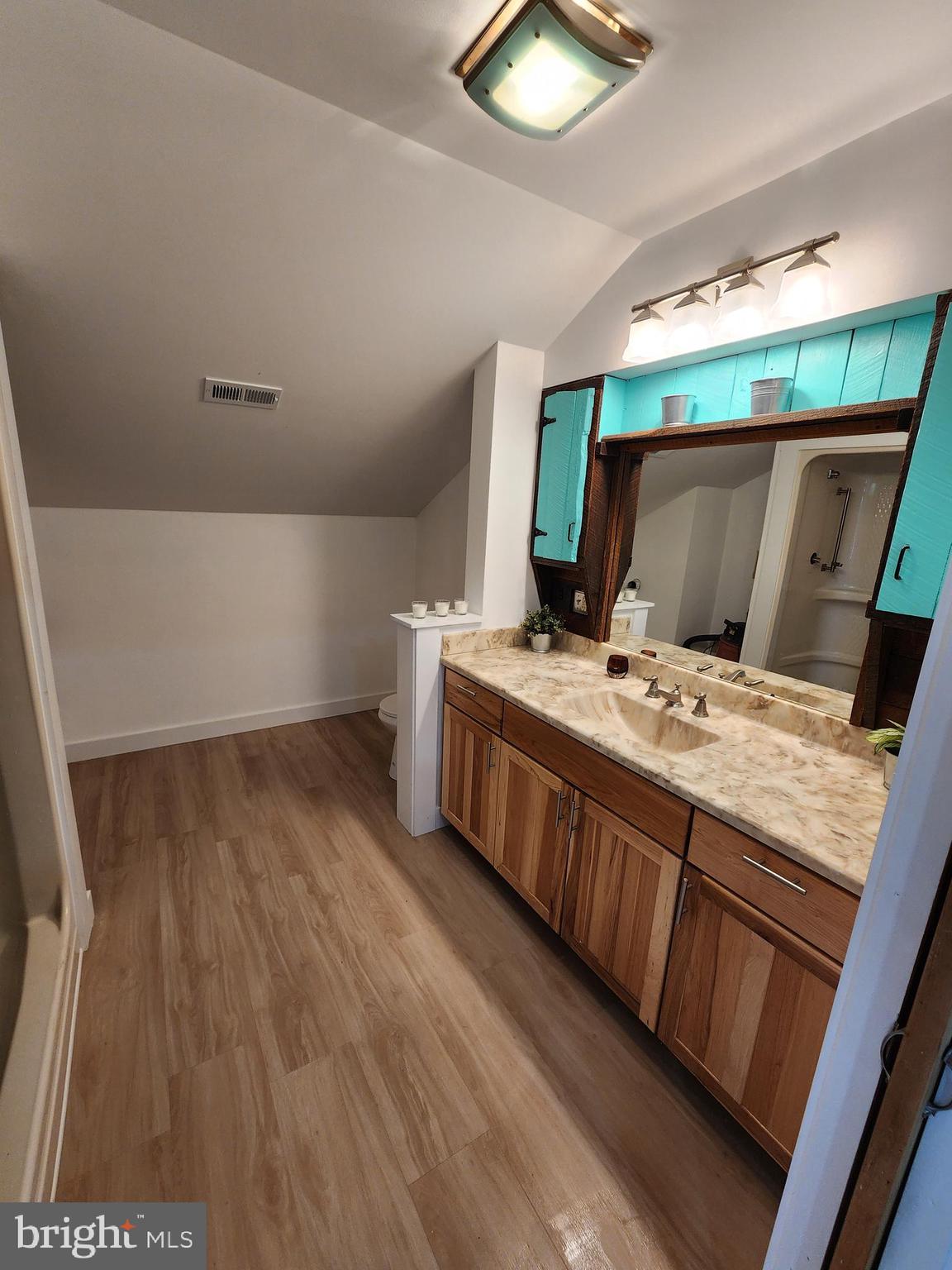 6366 Galestown-Reliance Road Federalsburg, MD 21632 - Photo 51 of 55 a living room with hard wood floors and a bed