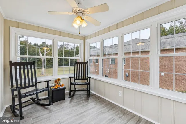 a view of a room with wooden floor and windows