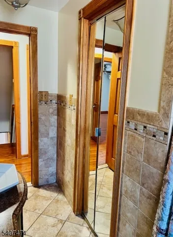 a bathroom with a glass door shower and a sink
