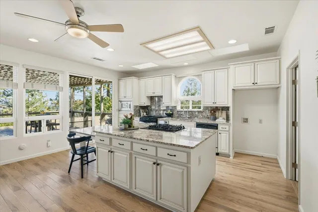 a spacious bedroom with a bed and ceiling fan