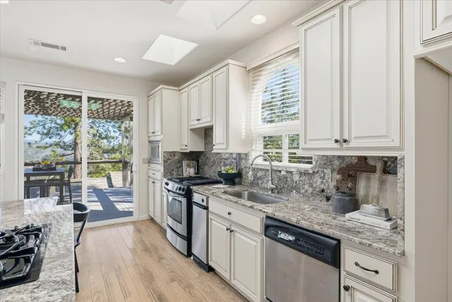 a spacious bedroom with a bed a couch and potted plant
