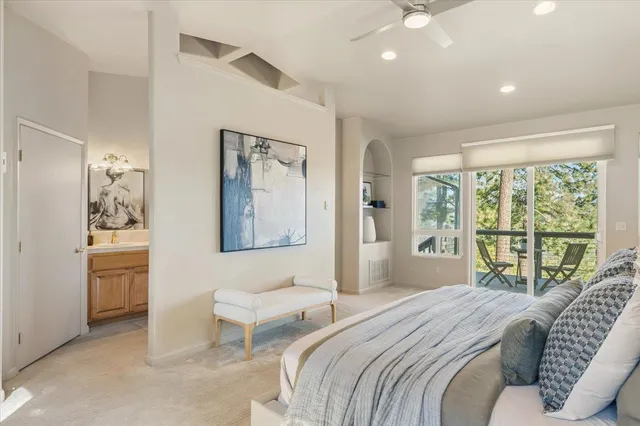 a spacious bathroom with a tub sink and mirror