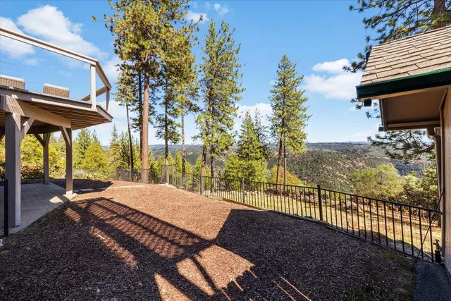 a view of a patio with table and chairs and potted plants