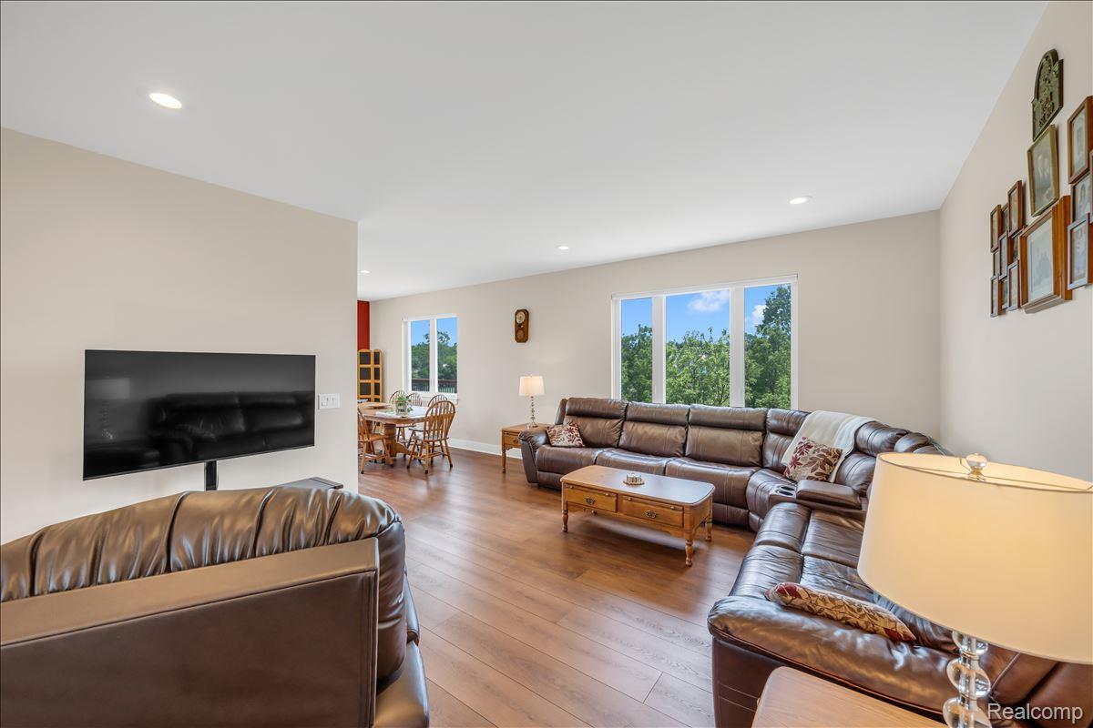 4266 McCandlish Road Grand Blanc, MI 48439 - Photo 15 of 68 Spacious living area featuring wood-finish flooring, recessed lighting, and large windows