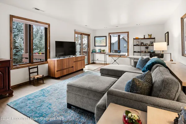 a living room with furniture and a flat screen tv