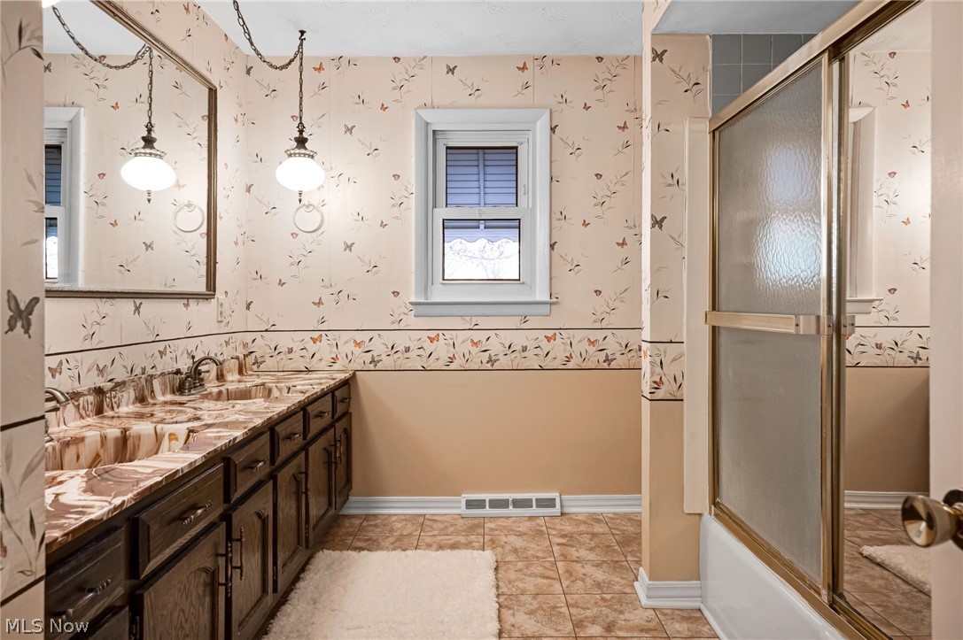 6452 Carsten Road Medina, OH 44256 - Photo 22 of 41 Bathroom with dual vanity, tile floors, and bath / shower combo with glass door