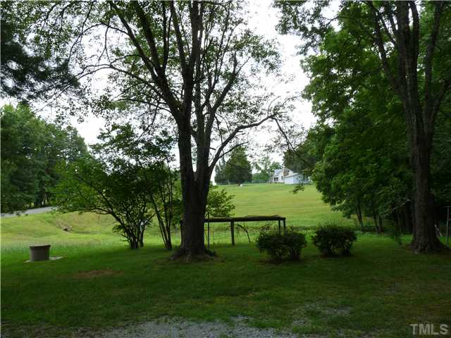 491 Carl Adcock Road Roxboro, NC 27574 - Photo 8 of 8 a view of a garden with a tree
