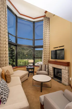 a living room with furniture a fireplace and a flat screen tv