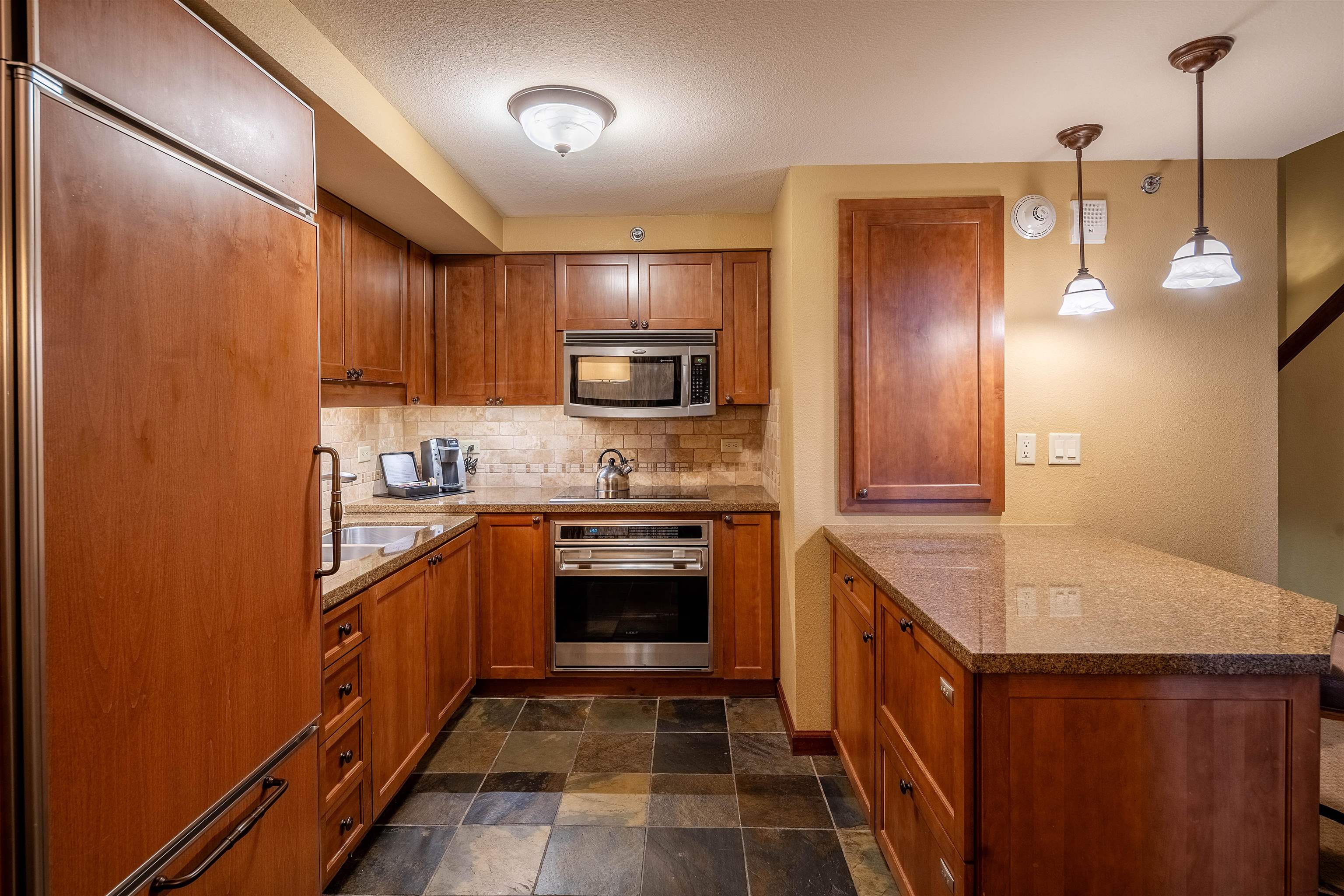 400 Resort Road, Unit 838 840 Olympic Valley, CA 96146 - Photo 5 of 21 a kitchen with stainless steel appliances granite countertop a stove a sink and a refrigerator