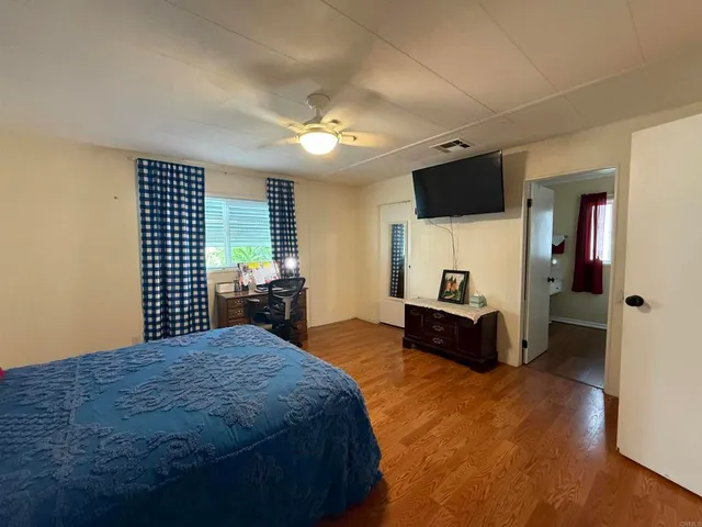 a large bedroom with a bed and a television