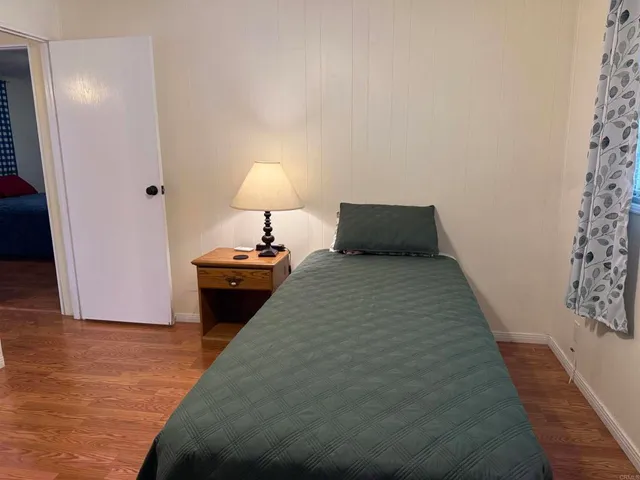 a bedroom with a bed and a lamp