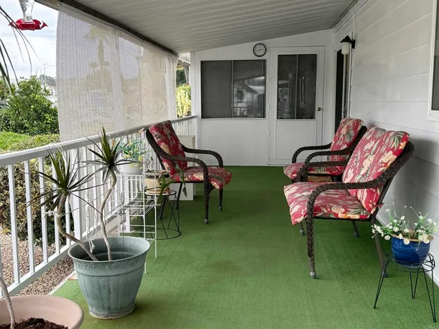 a building outdoor space with patio furniture and potted plants