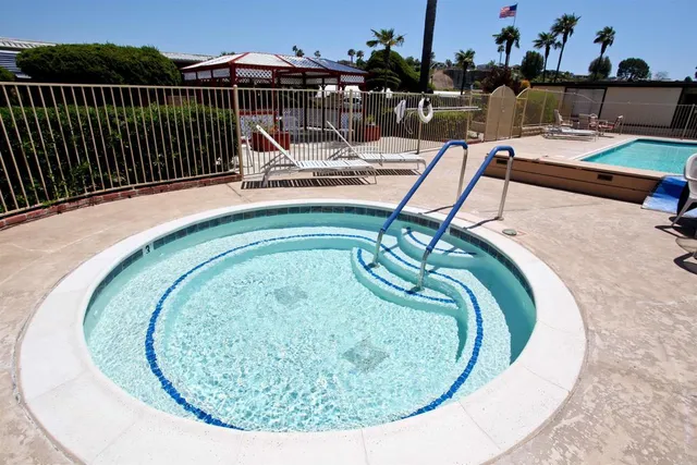 a view of a swimming pool with outdoor seating