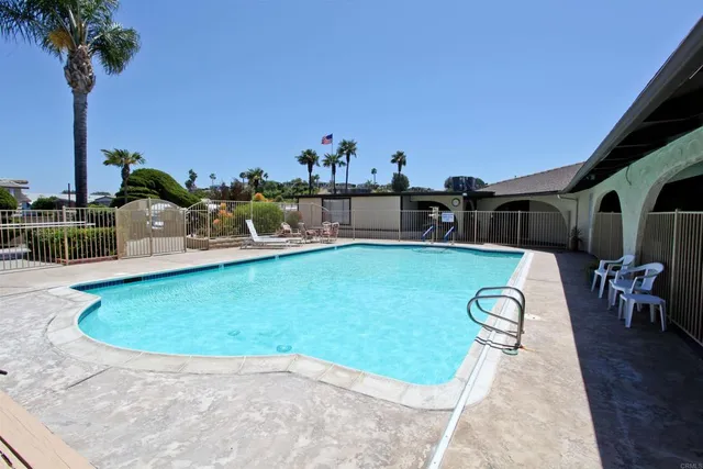a view of a swimming pool with a table and chairs
