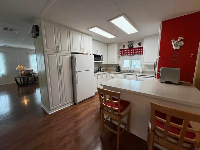 a kitchen with a sink appliances and cabinets