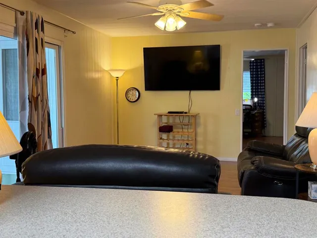 a living room with a flat screen tv and gym equipment