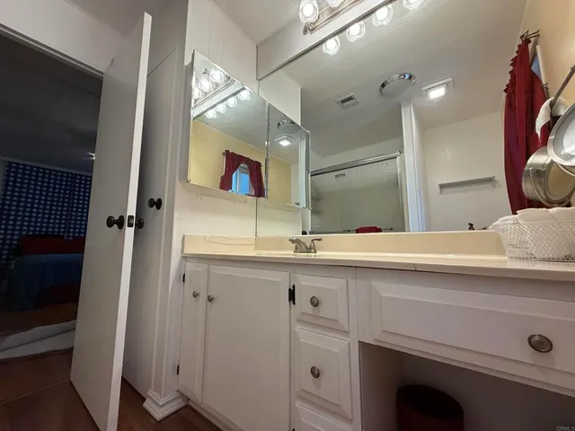 a bathroom with a sink a vanity and a mirror