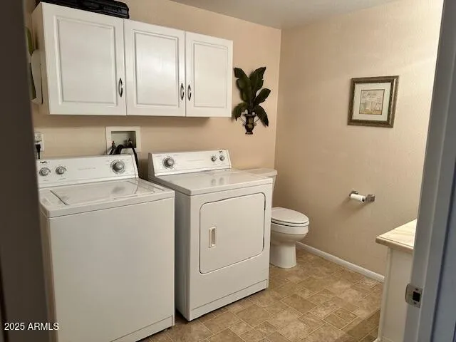 a view of bathroom with a washer and dryer