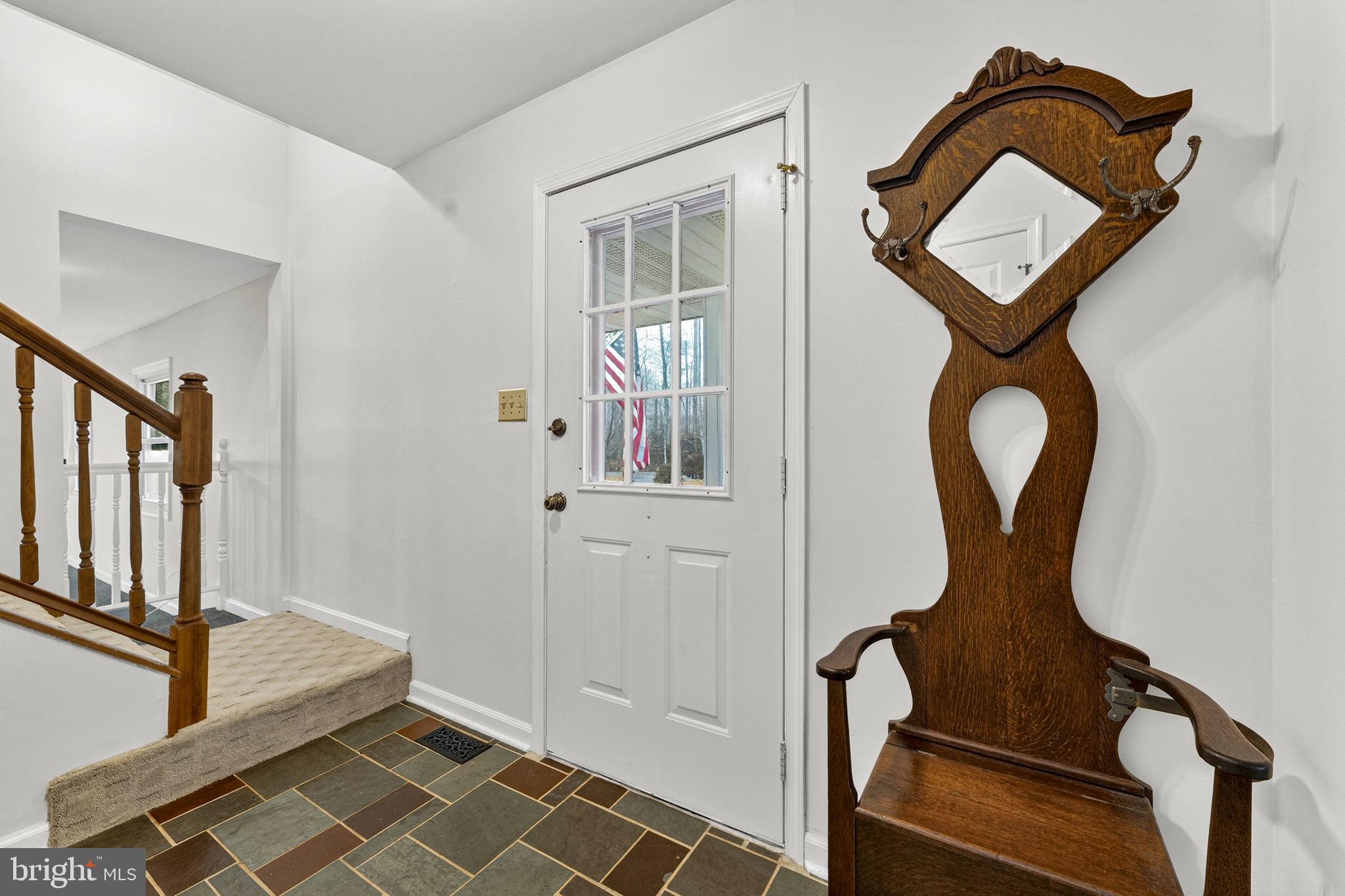 2266 Beaver Dam Road Midland, VA 22728 - Photo 16 of 93 a front view of a house with wooden floor windows and entryway