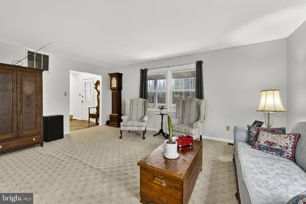 a living room with furniture and a lamp