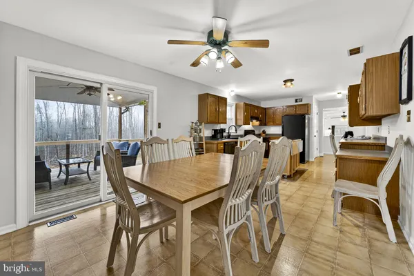 a view of a roof deck with table and chairs wooden floor and fence