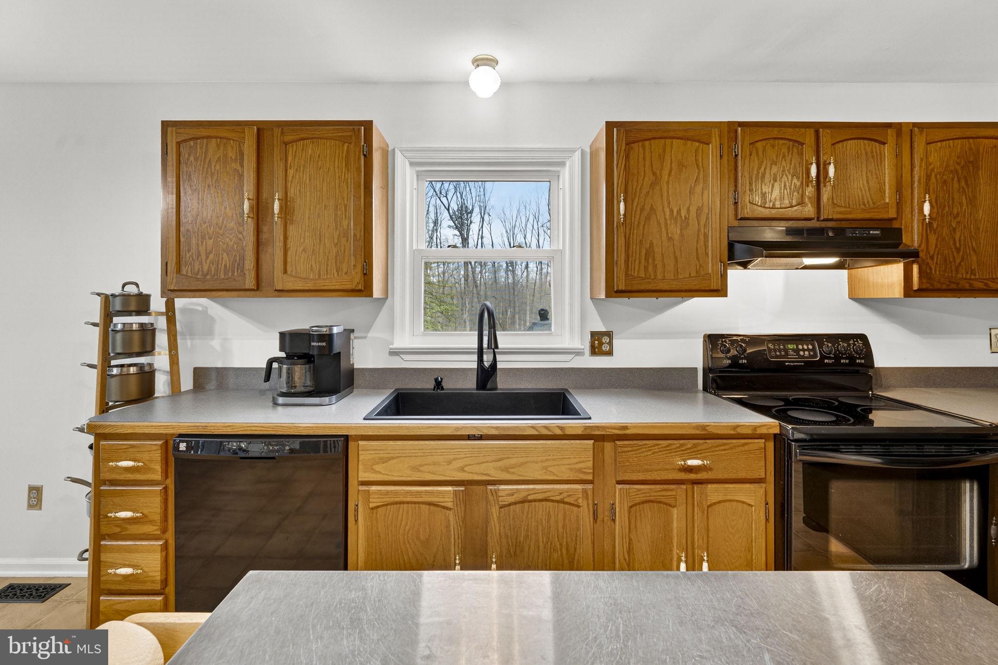 2266 Beaver Dam Road Midland, VA 22728 - Photo 33 of 93 a kitchen with stainless steel appliances granite countertop a stove sink and cabinets