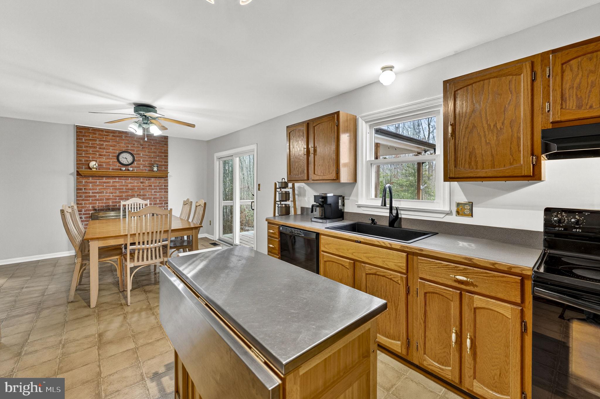 2266 Beaver Dam Road Midland, VA 22728 - Photo 34 of 93 a kitchen with a stove a sink a dining table and chairs