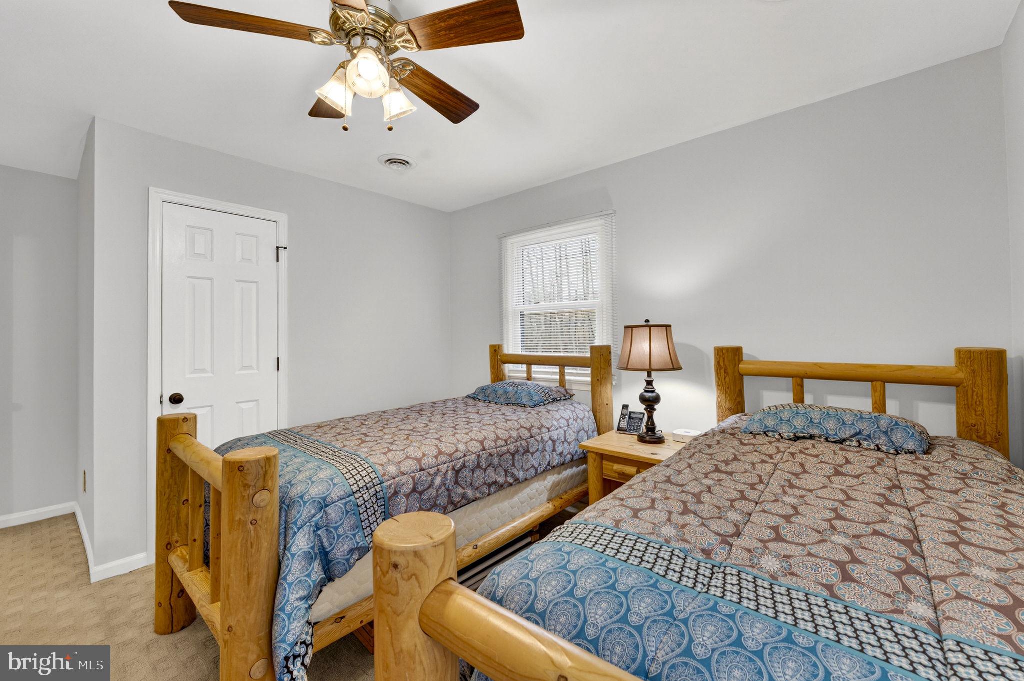 2266 Beaver Dam Road Midland, VA 22728 - Photo 60 of 93 a bedroom with two beds and a chandelier