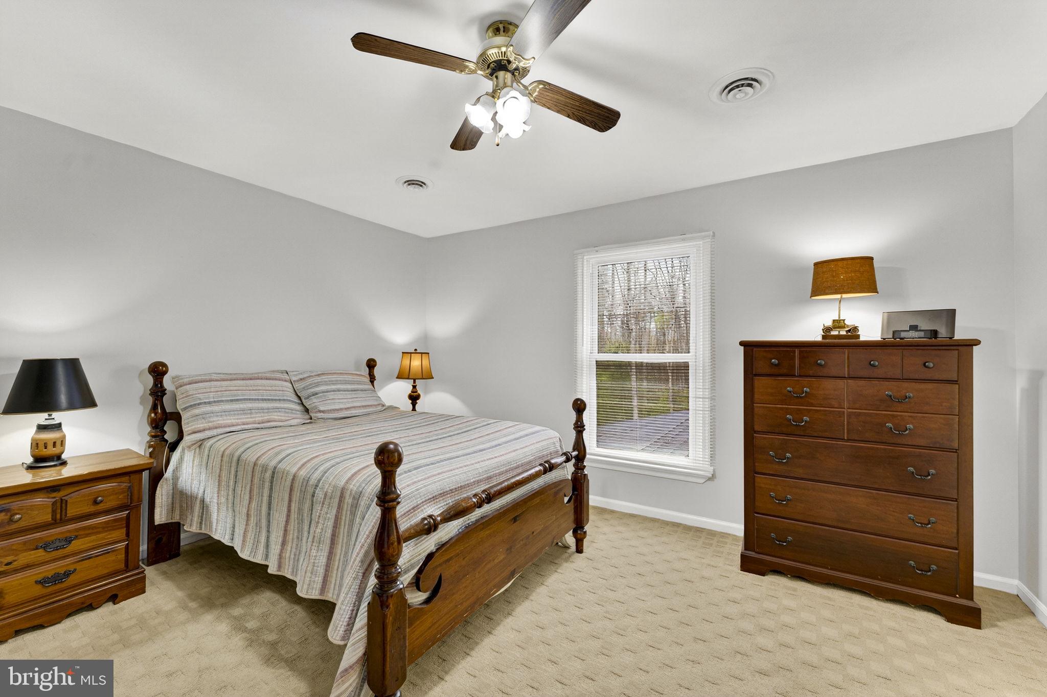 2266 Beaver Dam Road Midland, VA 22728 - Photo 61 of 93 a bedroom with a bed and a chandelier