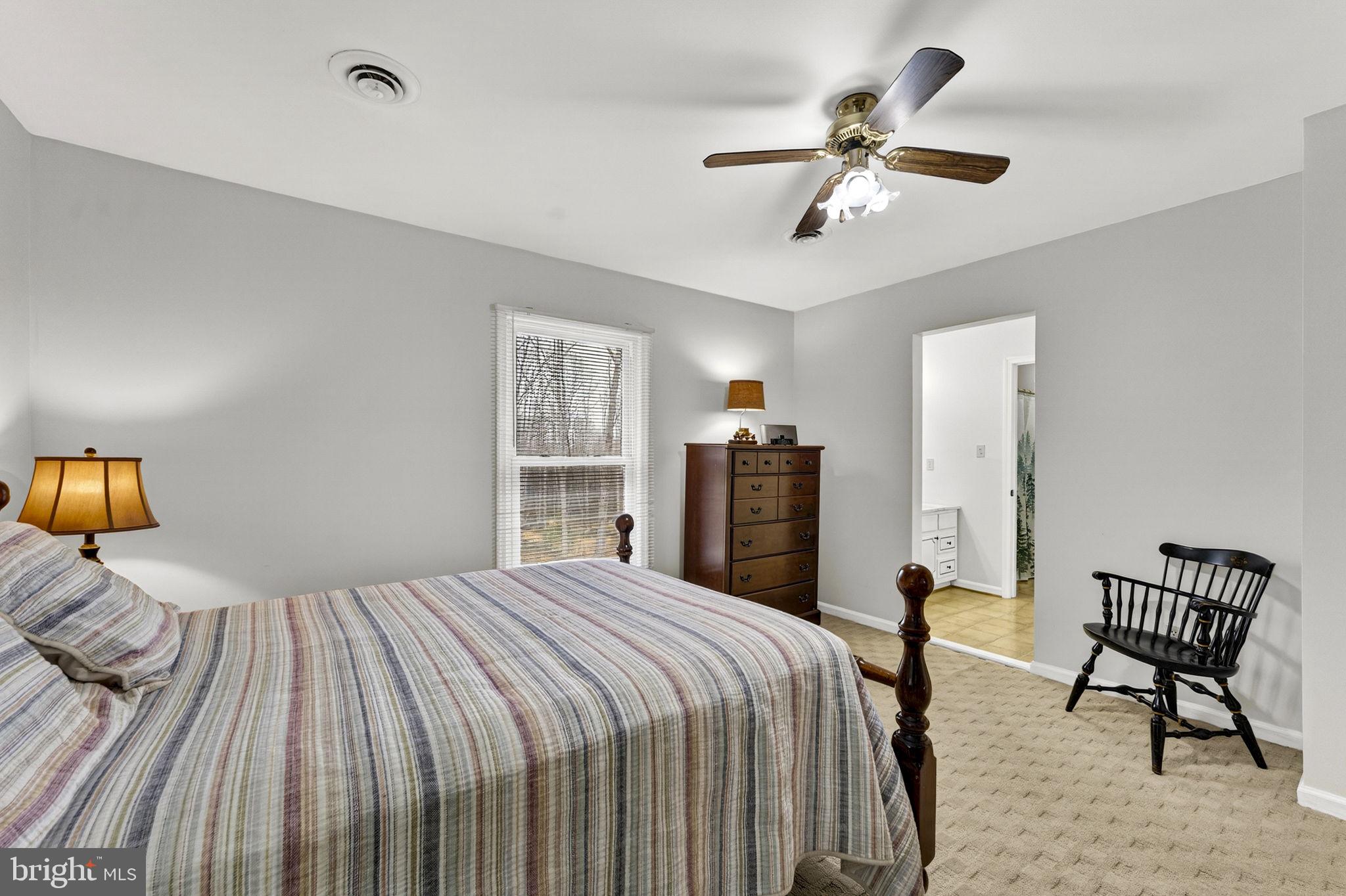2266 Beaver Dam Road Midland, VA 22728 - Photo 62 of 93 a bedroom with a bed and a chandelier