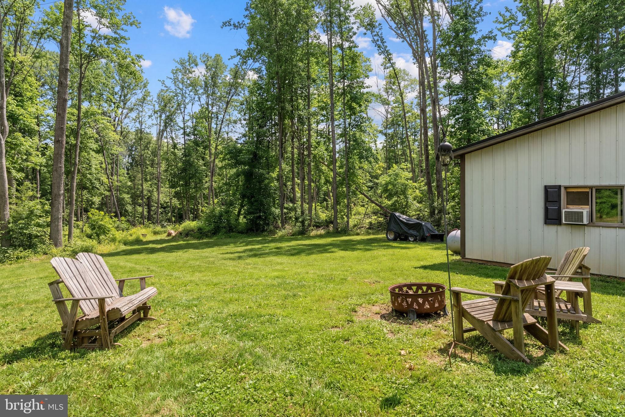 2266 Beaver Dam Road Midland, VA 22728 - Photo 85 of 93 a view of a backyard with table and chairs and a tree